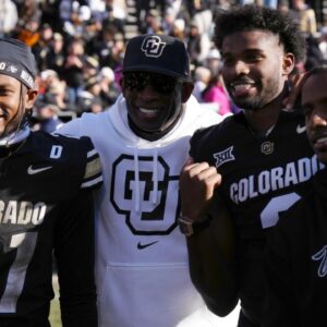 Colorado Buffaloes safety Shilo Sanders (21) and head coach Deion Sanders and quarterback Shedeur Sanders (2) and social media producer Deion Sanders Jr. following the win against the Oklahoma State Cowboys at Folsom Field.