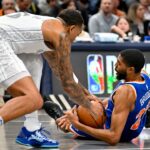 New York Knicks forward Mikal Bridges (25) and Dallas Mavericks forward P.J. Washington (25) battle for control of the ball during the first quarter against the Dallas Mavericks at the American Airlines Center.