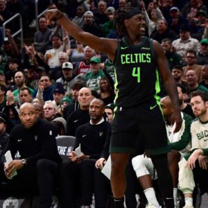 Boston Celtics guard Jrue Holiday (4) reacts after a three point basket during the second half against the Milwaukee Bucks at TD Garden.