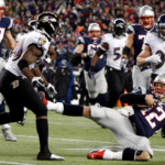 Jan 20, 2013; Foxboro, MA, USA; New England Patriots quarterback Tom Brady (12) slides to avoid a hit from Baltimore Ravens free safety Ed Reed (20) during the second quarter of the AFC championship game at Gillette Stadium. Mandatory Credit: David Butler II-Imagn Images