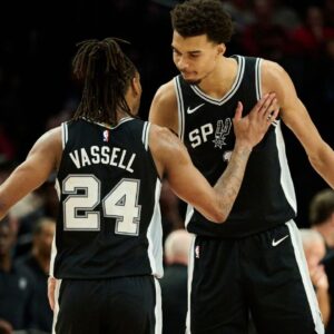 Victor Wembanyama celebrates with Devin Vassell