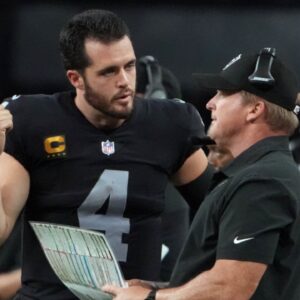 Sep 13, 2021; Paradise, Nevada, USA; Las Vegas Raiders quarterback Derek Carr (4) speaks with head coach Jon Gruden during the second half at Allegiant Stadium.