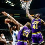 Utah Jazz center Mark Eaton (53) and Thurl Bailey (41) defend a shot by Orlando Magic forward Michael Ansley (45) at the Orlando Arena.