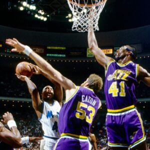 Utah Jazz center Mark Eaton (53) and Thurl Bailey (41) defend a shot by Orlando Magic forward Michael Ansley (45) at the Orlando Arena.