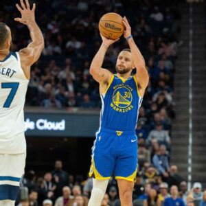 Golden State Warriors guard Stephen Curry (30) shoots a three point shot against Minnesota Timberwolves center Rudy Gobert (27) during the fourth quarter at Chase Center.