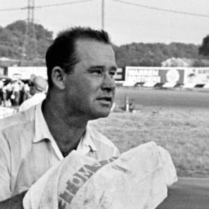 An exhausted Nelson Stacy wipes his parched lips with a towel as he rests on the guard rail at the Fairgrounds Speedway on May 17, 1964. Stacy pushed himself and his 1964 Ford to the limit in finishing second in the 300-lap ARCA race.