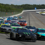 NASCAR Cup Series driver Denny Hamlin (11) races to the inside of driver Ty Gibbs (54) during The Great American Getaway 400 at Pocono Raceway.