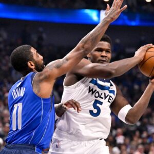 Minnesota Timberwolves guard Anthony Edwards (5) looks to pass the ball past Dallas Mavericks guard Kyrie Irving (11) during the first quarter at the American Airlines Center