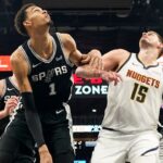 Denver Nuggets center Nikola Jokic (15) and San Antonio Spurs forward Victor Wembanyama (1) box out for a rebound during the second half at Frost Bank Center.