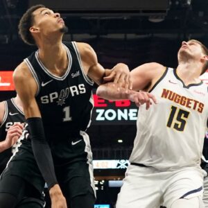 Denver Nuggets center Nikola Jokic (15) and San Antonio Spurs forward Victor Wembanyama (1) box out for a rebound during the second half at Frost Bank Center.