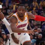 Golden State Warriors forward Jonathan Kuminga (00) dribbles by Minnesota Timberwolves forward Jaden McDaniels (3) in the fourth period at Chase Center.