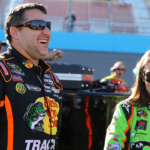 NASCAR Sprint Cup Series driver Tony Stewart (left) talks to teammate Danica Patrick during qualifying for the Subway Fresh Fit 500 at Phoenix International Raceway.