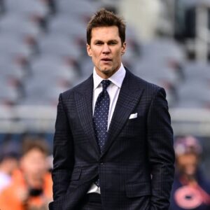 Former quarterback and current NFL announcer Tom Brady looks on before the game between the Chicago Bears and Green Bay Packers at Soldier Field.
