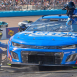 The pit crew of NASCAR Cup Series driver Kyle Larson (5) work to change the tires and remove a tear-off from the windshield during the United Rentals Work United 500 at Phoenix Raceway in Avondale on March 12, 2023.