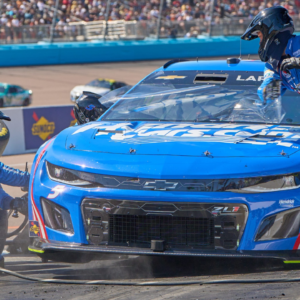 The pit crew of NASCAR Cup Series driver Kyle Larson (5) work to change the tires and remove a tear-off from the windshield during the United Rentals Work United 500 at Phoenix Raceway in Avondale on March 12, 2023.