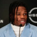 Colorado Buffaloes wide receiver/cornerback Travis Hunter speaks on stage during a press conference before the 2024 Heisman Trophy Presentation.