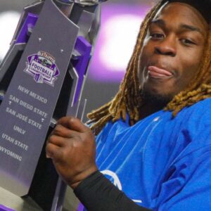 Boise State Broncos running back Ashton Jeanty (2) hoists the Mountain West Trophy after the game against the UNLV Rebels at Albertsons Stadium. Boise State beats UNLV 21-7.