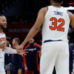 New York Knicks guard Jalen Brunson (11) celebrates with Knicks center Karl-Anthony Towns (32) against the Washington Wizards in the fourth quarter at Capital One Arena.