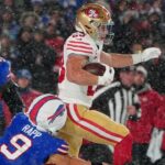 Dec 1, 2024; Orchard Park, New York, USA;San Francisco 49ers running back Christian McCaffrey (23) runs with the ball past Buffalo Bills safety Taylor Rapp (9) during the first half at Highmark Stadium.