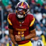 Dec 22, 2024; Landover, Maryland, USA; Washington Commanders quarterback Jayden Daniels (5) celebrates after throwing the game winning touchdown during the fourth quarter against the Philadelphia Eagles at Northwest Stadium.
