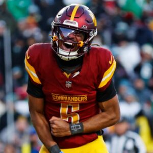 Dec 22, 2024; Landover, Maryland, USA; Washington Commanders quarterback Jayden Daniels (5) celebrates after throwing the game winning touchdown during the fourth quarter against the Philadelphia Eagles at Northwest Stadium.