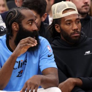 Los Angeles Clippers guard James Harden (1, left) and Kawhi Leonard (right) watch the game against the Utah Jazz from the bench during the fourth quarter at Intuit Dome.