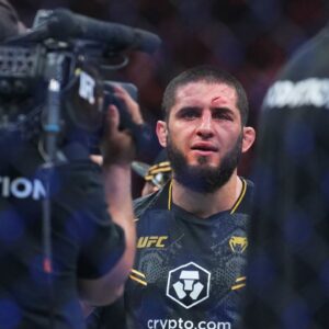 ; Islam Makhachev (red gloves) celebrates defeating Dustin Poirier (blue gloves) during UFC 302 at Prudential Center.