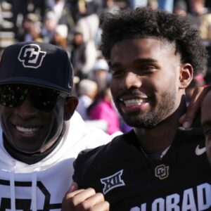 Nov 29, 2024; Boulder, Colorado, USA; Colorado Buffaloes safety Shilo Sanders (21) and head coach Deion Sanders and quarterback Shedeur Sanders (2) and social media producer Deion Sanders Jr. following the win against the Oklahoma State Cowboys at Folsom Field.