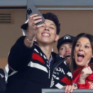 Jan 28, 2024; Baltimore, Maryland, USA; Brittany Mahomes (L) and Jackson Mahomes (M) celebrate in a suite against the Baltimore Ravens in the final minute in the AFC Championship football game at M&T Bank Stadium.