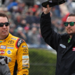 NASCAR Cup Series driver Kyle Busch (left) and driver Kurt Busch (right) wave to the fans prior to the Pocono 400 at Pocono Raceway.