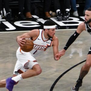 Phoenix Suns guard Devin Booker (1) drives to the basket while being defended by Brooklyn Nets guard Tyrese Martin (13) during the second half at Barclays Center