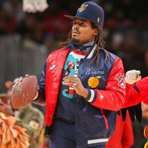 Former NFL quarterback Cam Newton on the court during a game between the Atlanta Hawks and Detroit Pistons in the second quarter at State Farm Arena.