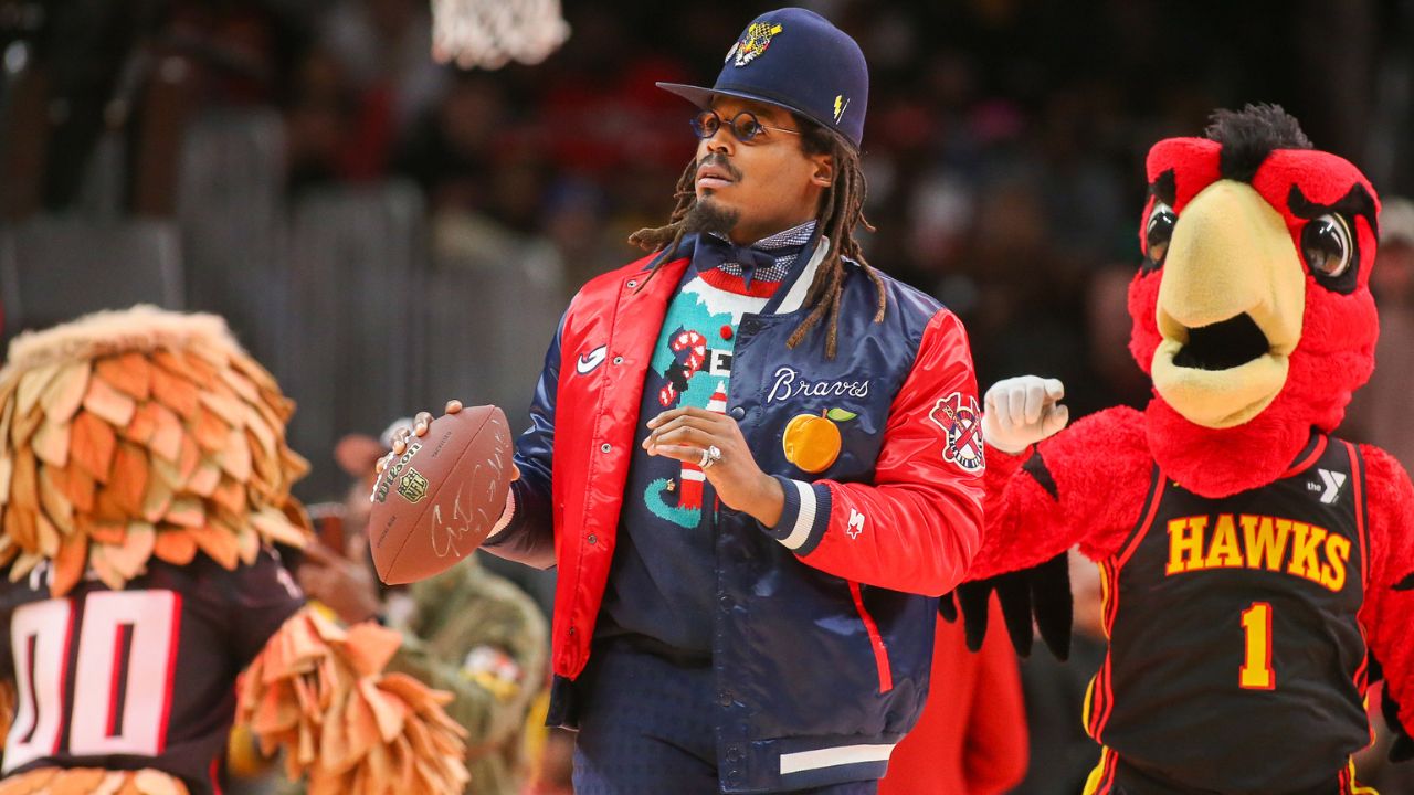 Former NFL quarterback Cam Newton on the court during a game between the Atlanta Hawks and Detroit Pistons in the second quarter at State Farm Arena.