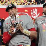 Jan 26, 2025; Kansas City, MO, USA; Kansas City Chiefs quarterback Patrick Mahomes (15) reacts after holding the Lamar Hunt Trophy after the AFC Championship game against the Buffalo Bills at GEHA Field at Arrowhead Stadium.