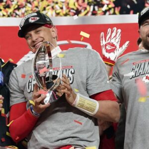 Jan 26, 2025; Kansas City, MO, USA; Kansas City Chiefs quarterback Patrick Mahomes (15) reacts after holding the Lamar Hunt Trophy after the AFC Championship game against the Buffalo Bills at GEHA Field at Arrowhead Stadium.