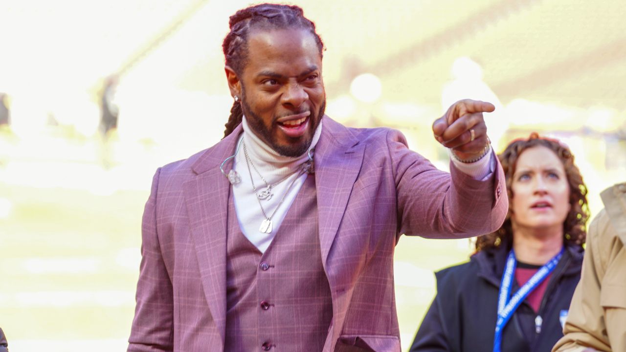 Commentator Richard Sherman signals to fans prior to a game between the Kansas City Chiefs and Las Vegas Raiders at GEHA Field at Arrowhead Stadium.
