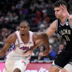 Philadelphia 76ers guard Tyrese Maxey (0) drives to the basket against Milwaukee Bucks center Brook Lopez (11) int he second half at Fiserv Forum