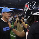 Jan 11, 2025; Houston, Texas, USA; Houston Texans quarterback C.J. Stroud (7) hugs Los Angeles Chargers head coach Jim Harbaugh after defeating the Los Angeles Chargers in an AFC wild card game at NRG Stadium.