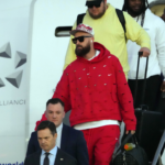 Kansas City Chiefs tight end Travis Kelce exits plane during Super Bowl 58 team arrivals at the Harry Reid International Airport.