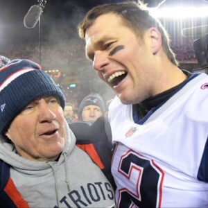 New England Patriots head coach Bill Belichick and quarterback Tom Brady (12) celebrate the win over the Kansas City Chiefs during overtime in the AFC Championship game at Arrowhead Stadium.