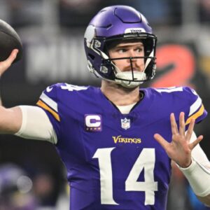 Dec 29, 2024; Minneapolis, Minnesota, USA; Minnesota Vikings quarterback Sam Darnold (14) throws a pass against the Green Bay Packers during the first quarter at U.S. Bank Stadium.