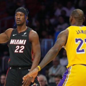 Miami Heat forward Jimmy Butler (22) looks to pass against Los Angeles Lakers forward LeBron James (23) in the first half at Kaseya Center.
