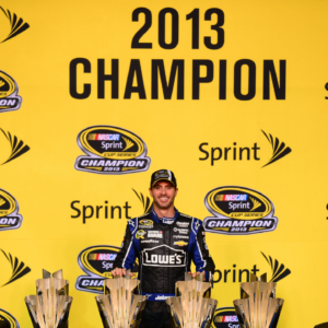 NASCAR Sprint Cup Series driver Jimmie Johnson poses with six Sprint Cup championship trophies after the Ford EcoBoost 400 at Homestead-Miami Speedway.