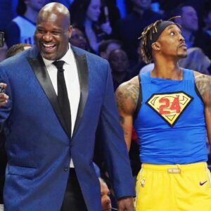 Former NBA player Shaquille O'Neal laughs while standing next to Los Angeles Lakers player Dwight Howard during the slam dunk contest during NBA All Star Saturday Night at United Center.