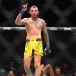 Renato Moicano (blue gloves) reacts after defeating Jalin Turner (red gloves) during UFC 300 at T-Mobile Arena.