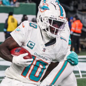 Jan 5, 2025; East Rutherford, New Jersey, USA; Miami Dolphins wide receiver Tyreek Hill (10) is tackled by New York Jets running back Isaiah Davis (32) during a punt return during the first half at MetLife Stadium.