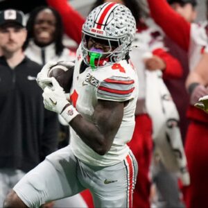 Ohio State Buckeyes wide receiver Jeremiah Smith (4) makes a catch against Notre Dame Fighting Irish cornerback Christian Gray (29) in the fourth quarter during the College Football Playoff National Championship at Mercedes-Benz Stadium in Atlanta on January 20, 2025.