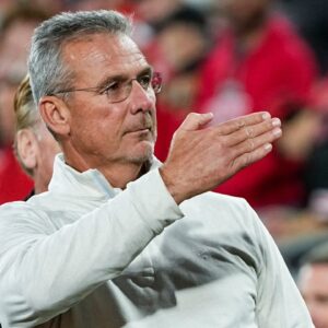 Former Ohio State Buckeyes head coach Urban Meyer salutes the fans chanting his name during the College Football Playoff quarterfinal against the Oregon Ducks at the Rose Bowl in Pasadena, Calif.