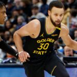 Golden State Warriors guard Stephen Curry (30) dribbles against Detroit Pistons guard Marcus Sasser (25) in the second half at Little Caesars Arena.