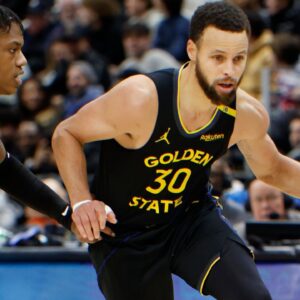Golden State Warriors guard Stephen Curry (30) dribbles against Detroit Pistons guard Marcus Sasser (25) in the second half at Little Caesars Arena.